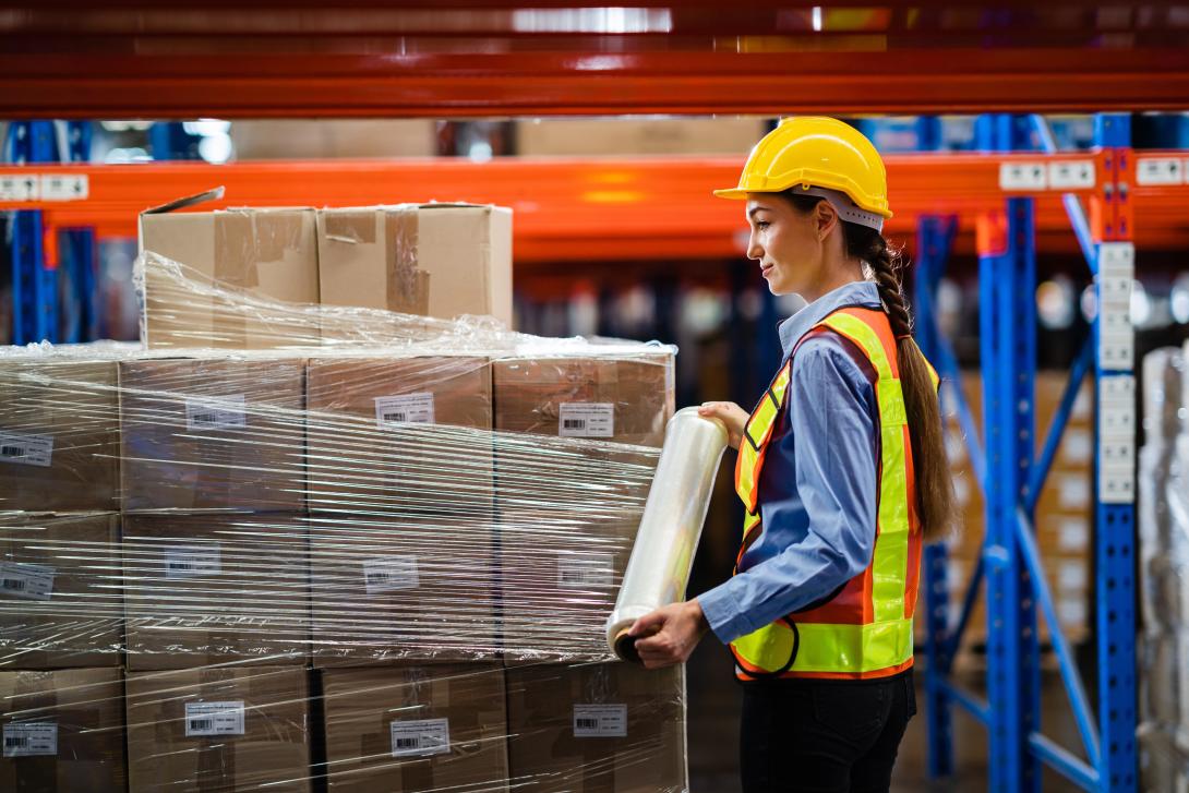 Woman filming pallet with foil